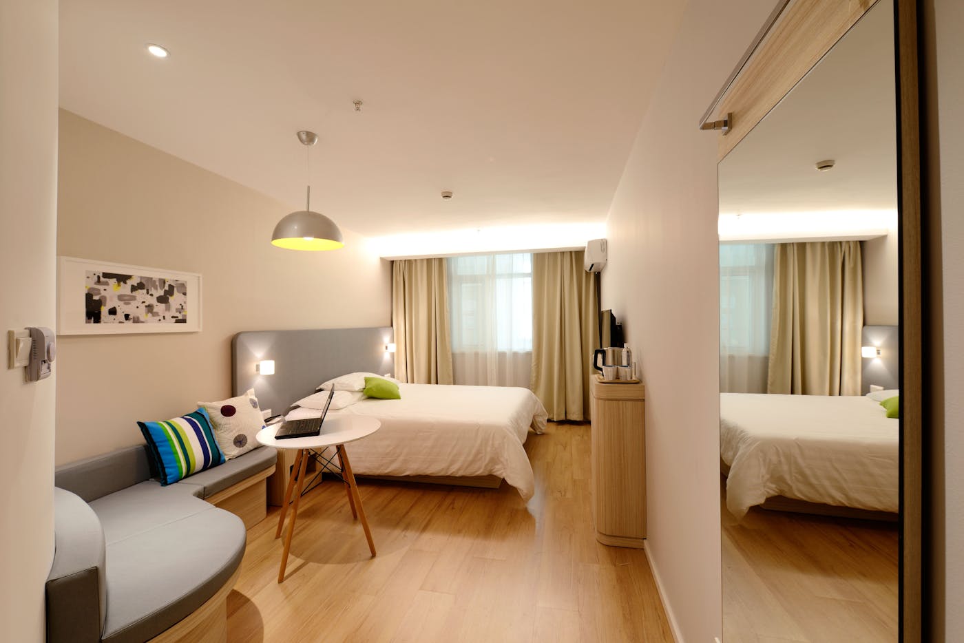 Bright boutique hotel bedroom in neutral tones — Wren Hotel Group project