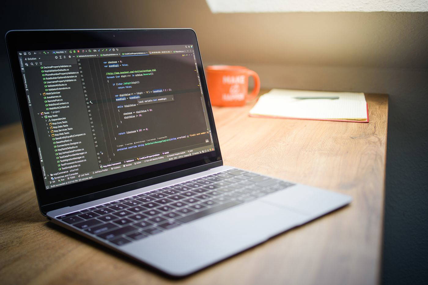 Laptop showing code in a modern workspace — Relay Analytics project